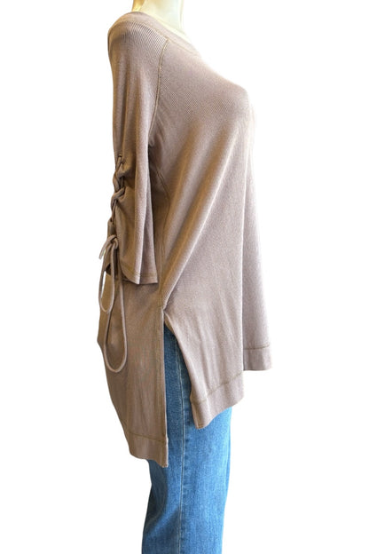 A taupe knit top with side lace-up detailing, shown on a mannequin from a side profile view against a white background.