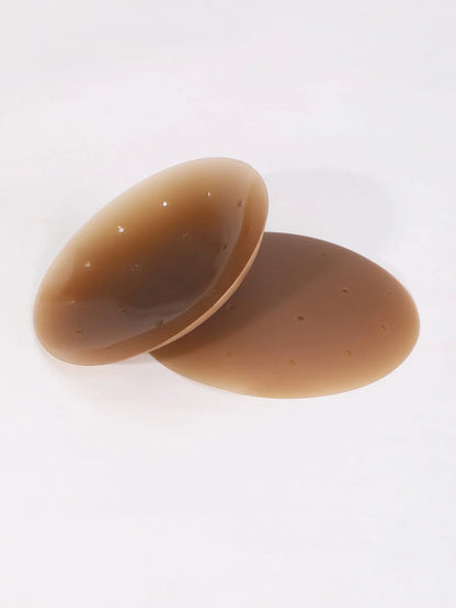 Two brown nipple covers on a white background