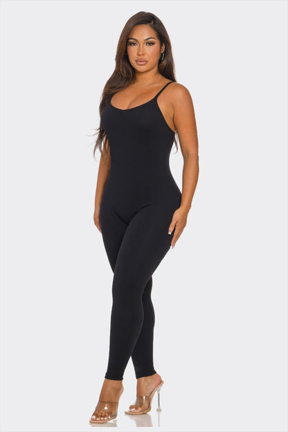 Woman wearing a black bodysuit on a white background