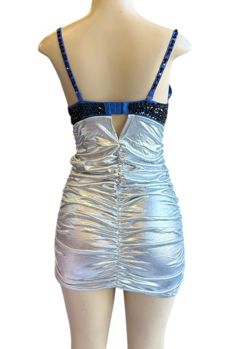 Silver dress with blue and black embellishments on a mannequin against a white background