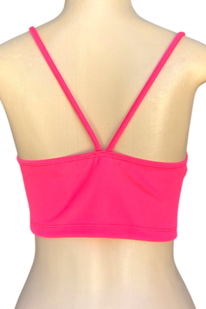Pink crop top on a mannequin with a white background