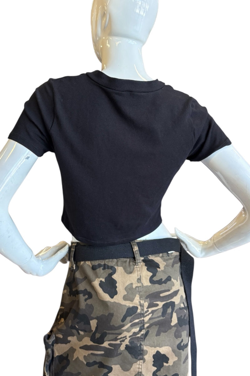 A black short-sleeve crop top shown from the back on a white mannequin, paired with a camouflage cargo skirt against a plain white background.