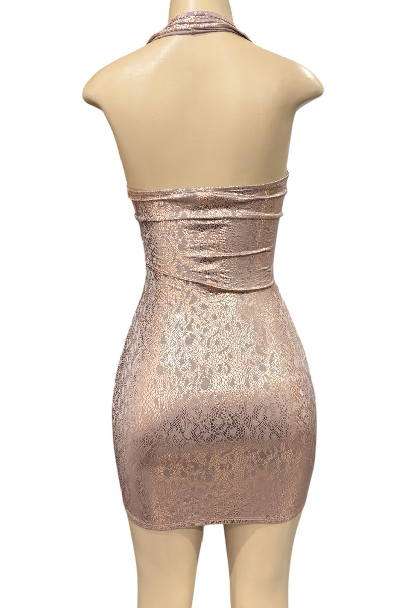 Gold metallic dress on a mannequin against a white background