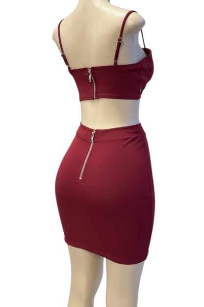 burgundy two-piece outfit with a crop top and skirt on a mannequin against a white background
