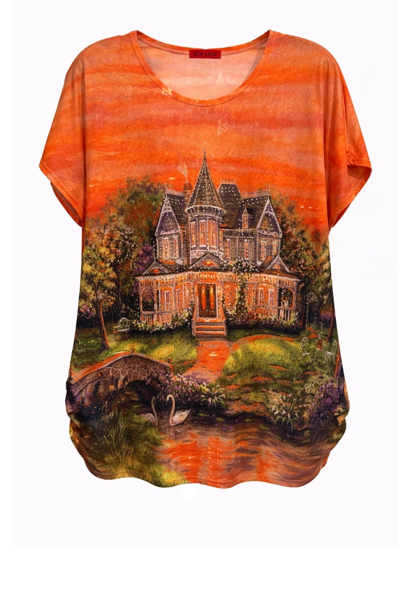 Orange t-shirt with a printed design of a house and landscape.