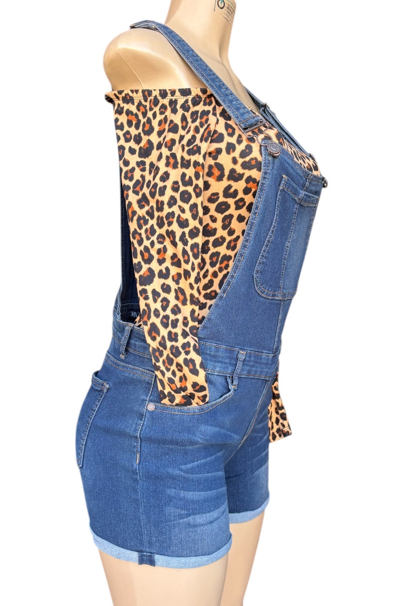 Denim overalls with leopard print top on a mannequin against a white background