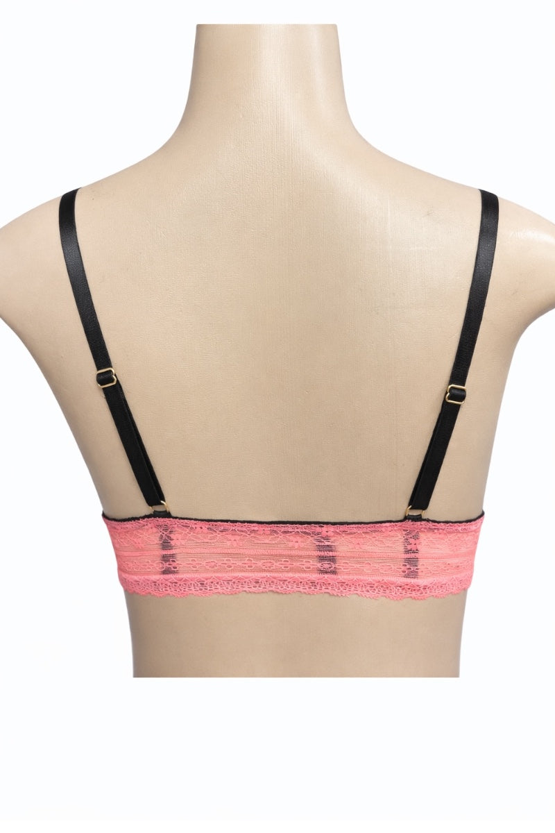 Mannequin wearing a coral lace bra with black straps on a white background