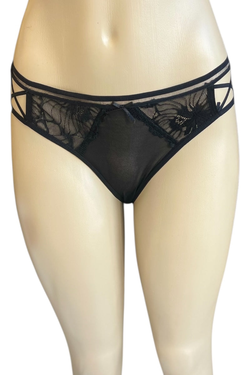 Black lace panty on a mannequin against a white background