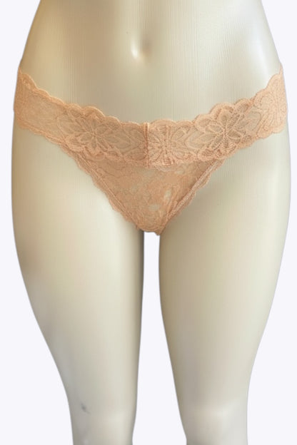Beige lace underwear on a mannequin against a white background
