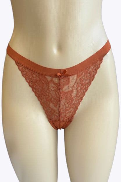 Red lace thong on a mannequin against a white background