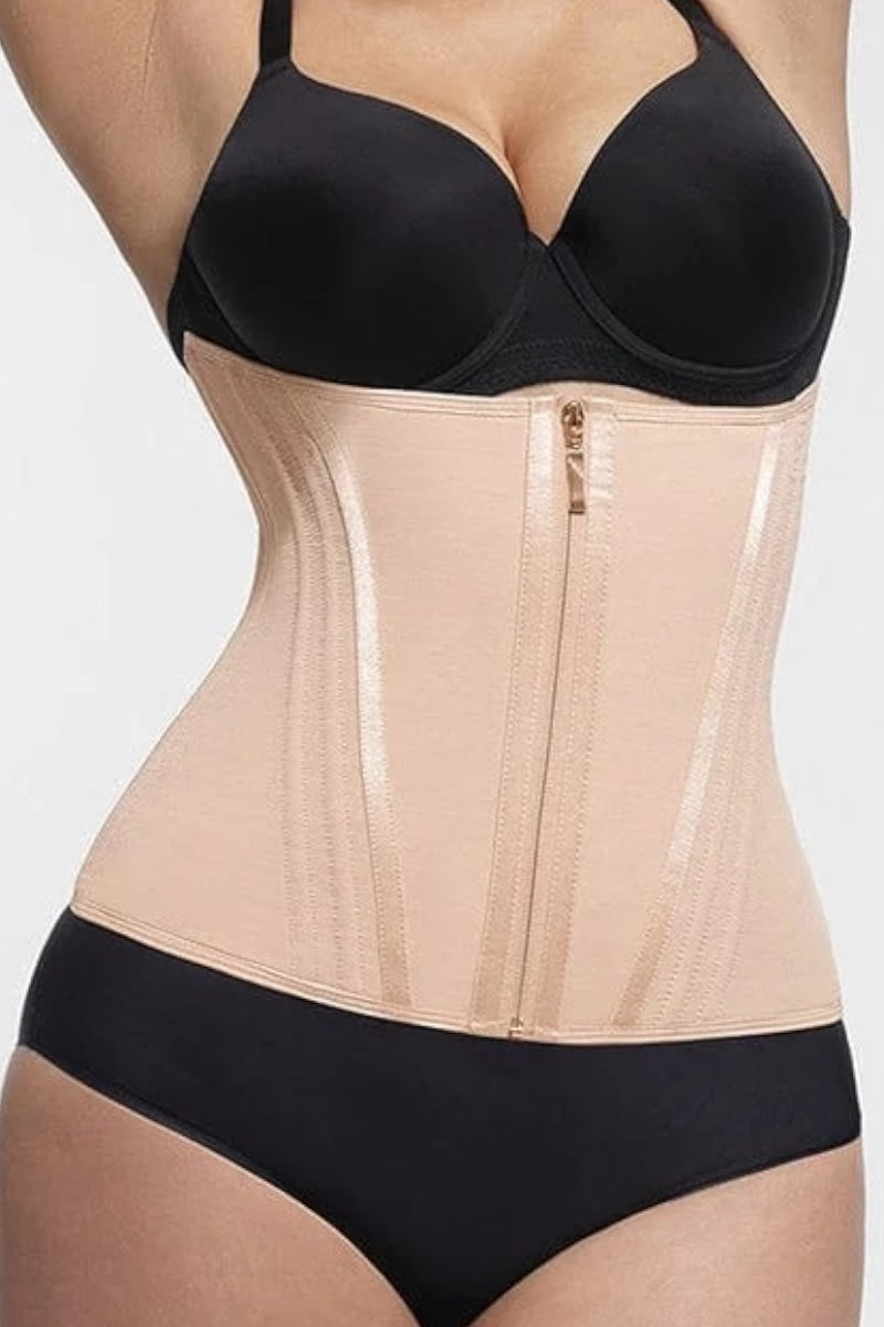 Person wearing a black bra and beige waist trainer on a plain background