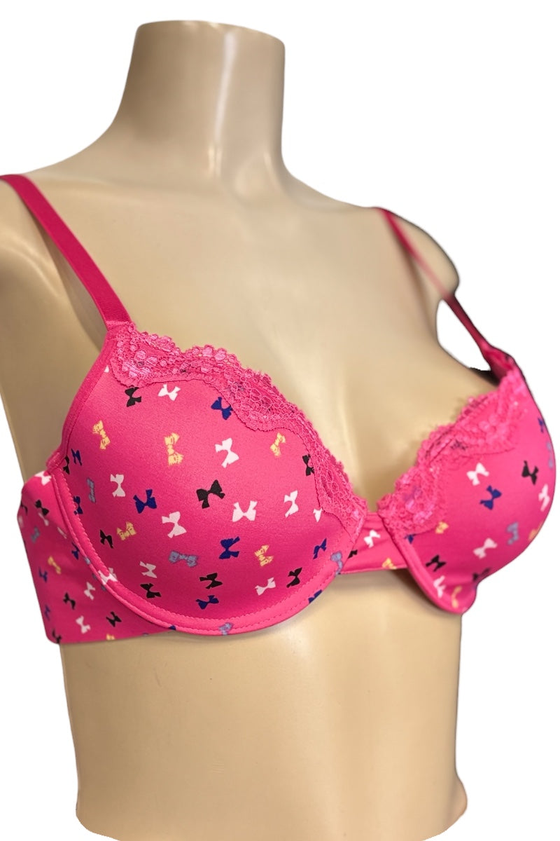 Pink bra with bow pattern on a mannequin against a white background