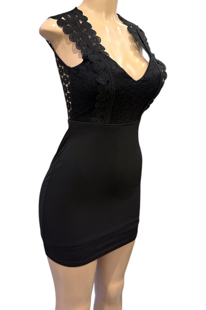 Black lace dress on a mannequin against a white background