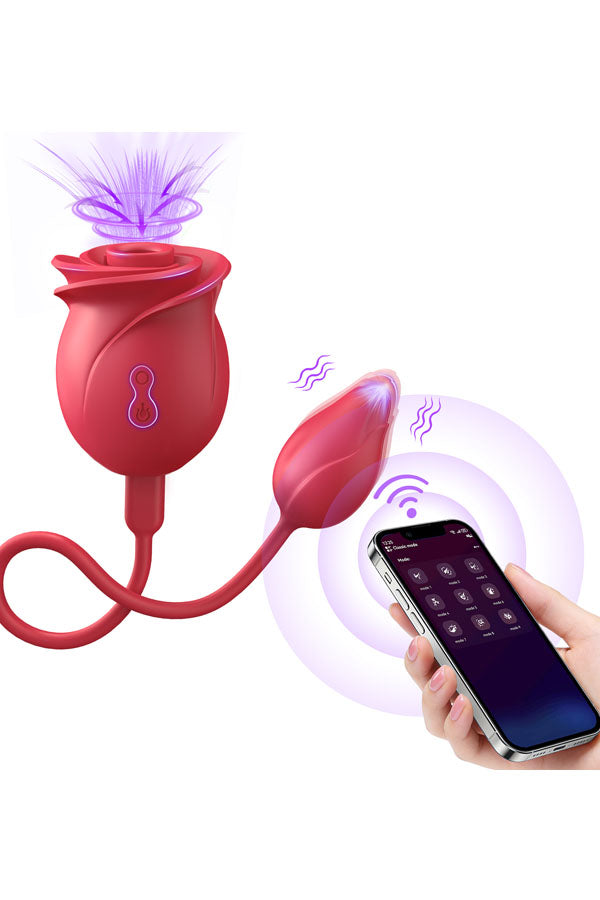 Red rose-shaped intimate device with a flexible bulb and purple glow effects, shown with a hand holding a smartphone on a white background.