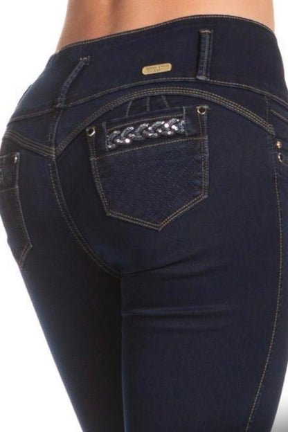 Dark blue jeans with a decorative pocket on a white background