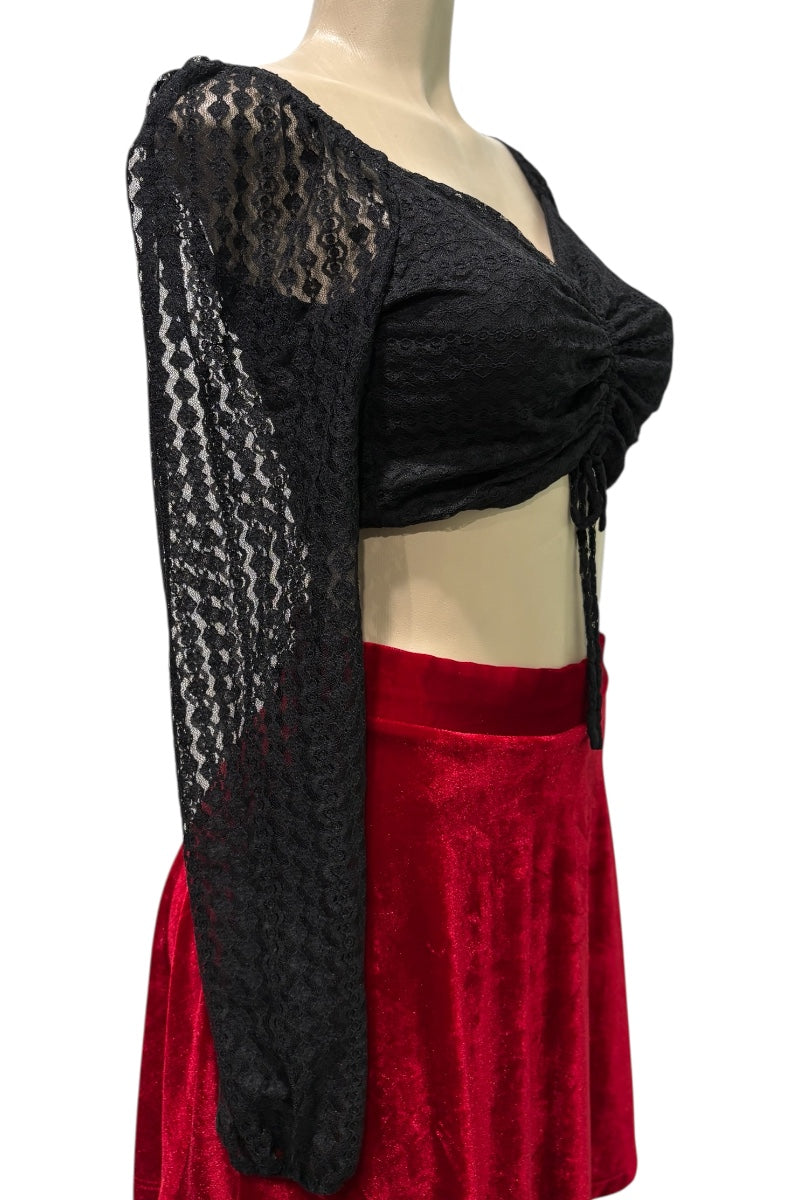 Mannequin wearing a black lace top and red skirt on a white background