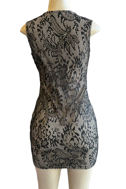 Black lace dress on a mannequin against a white background
