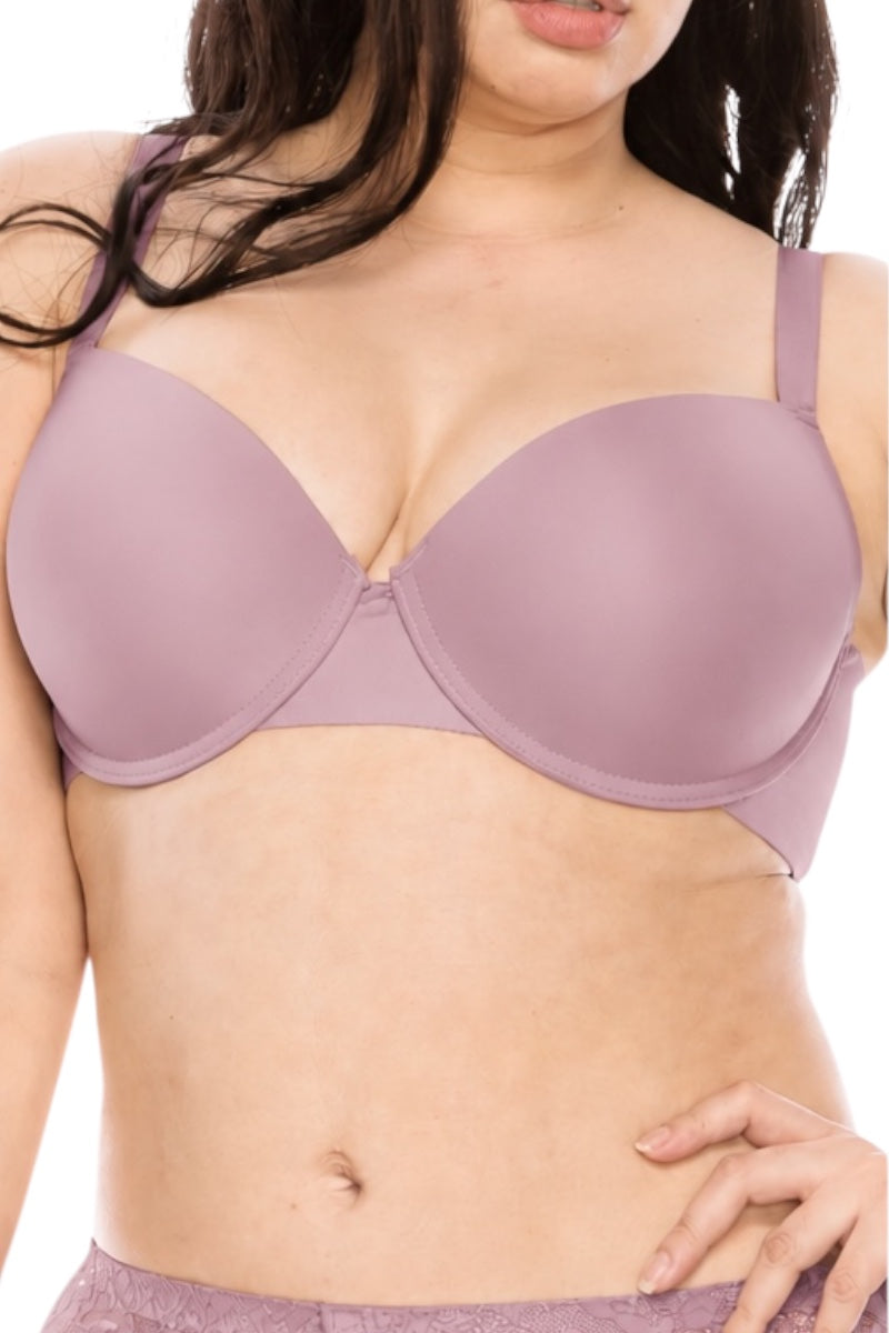 A close-up of a woman wearing a seamless, underwire bra in a dusty mauve or lavender shade. The image is cropped from the lower face to the waist, showing the fit on a model against a plain white background.