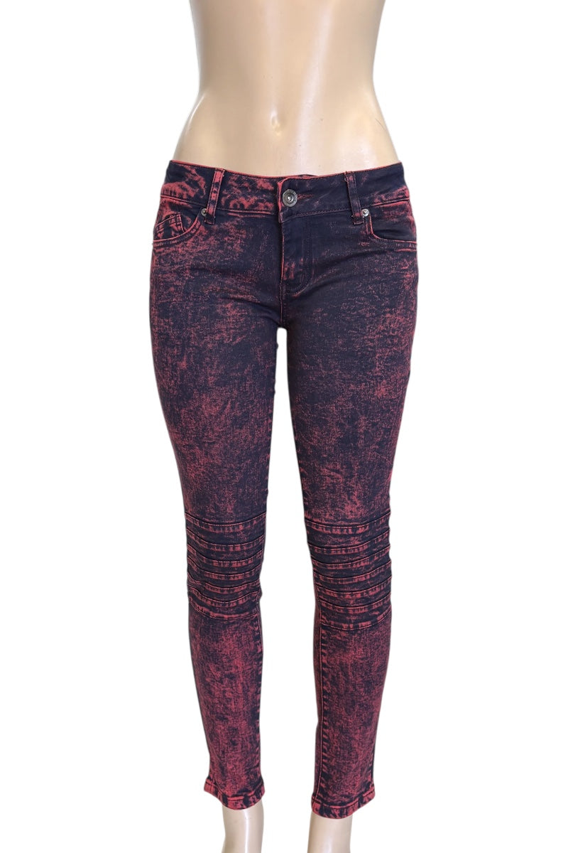 Red and black distressed jeans on a mannequin against a white background