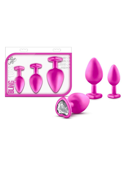 Pink silicone butt plugs with packaging on a white background