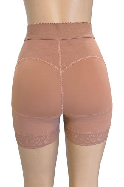 High-waisted shapewear shorts shown from the back on a mannequin, in a beige color with lace trim at the leg hems.