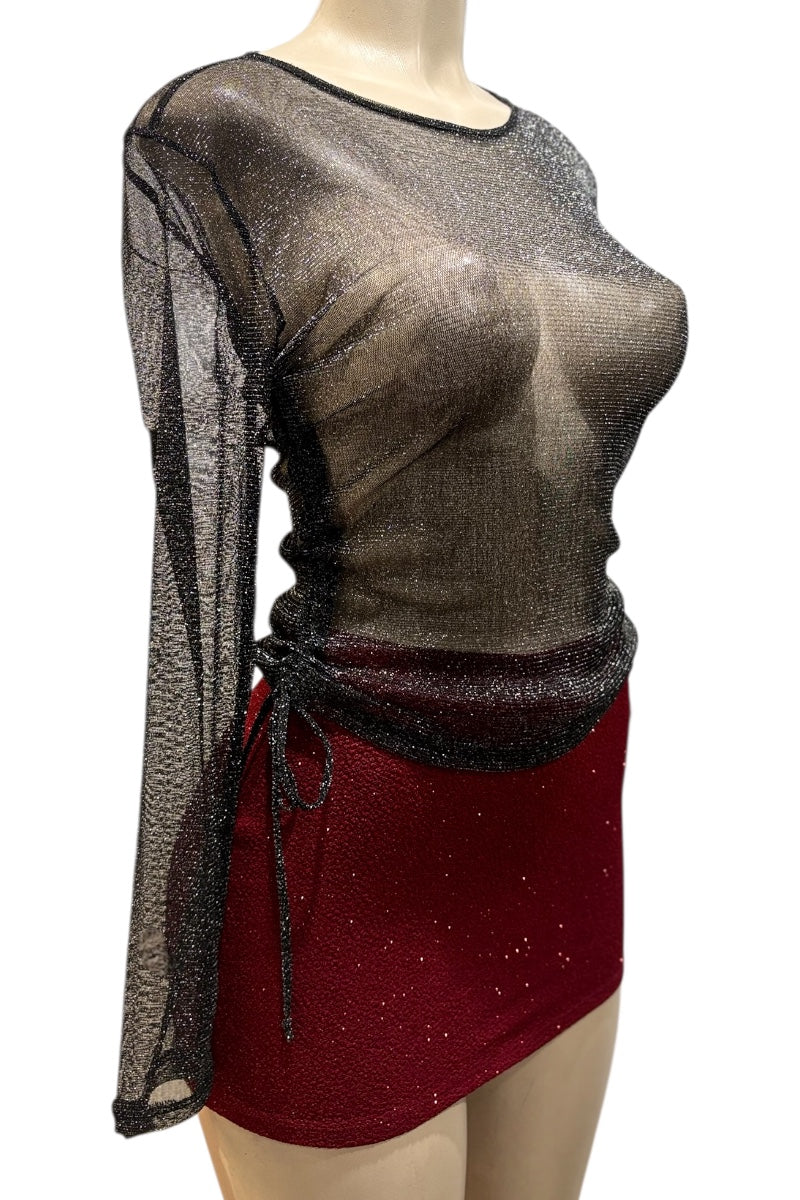 Mannequin wearing a sheer top and red skirt with black accents on a white background