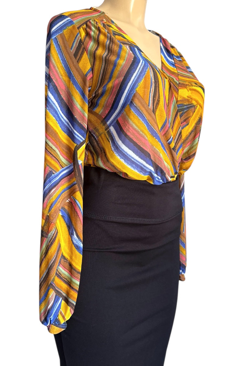 Colorful patterned blouse with long sleeves on a mannequin against a white background