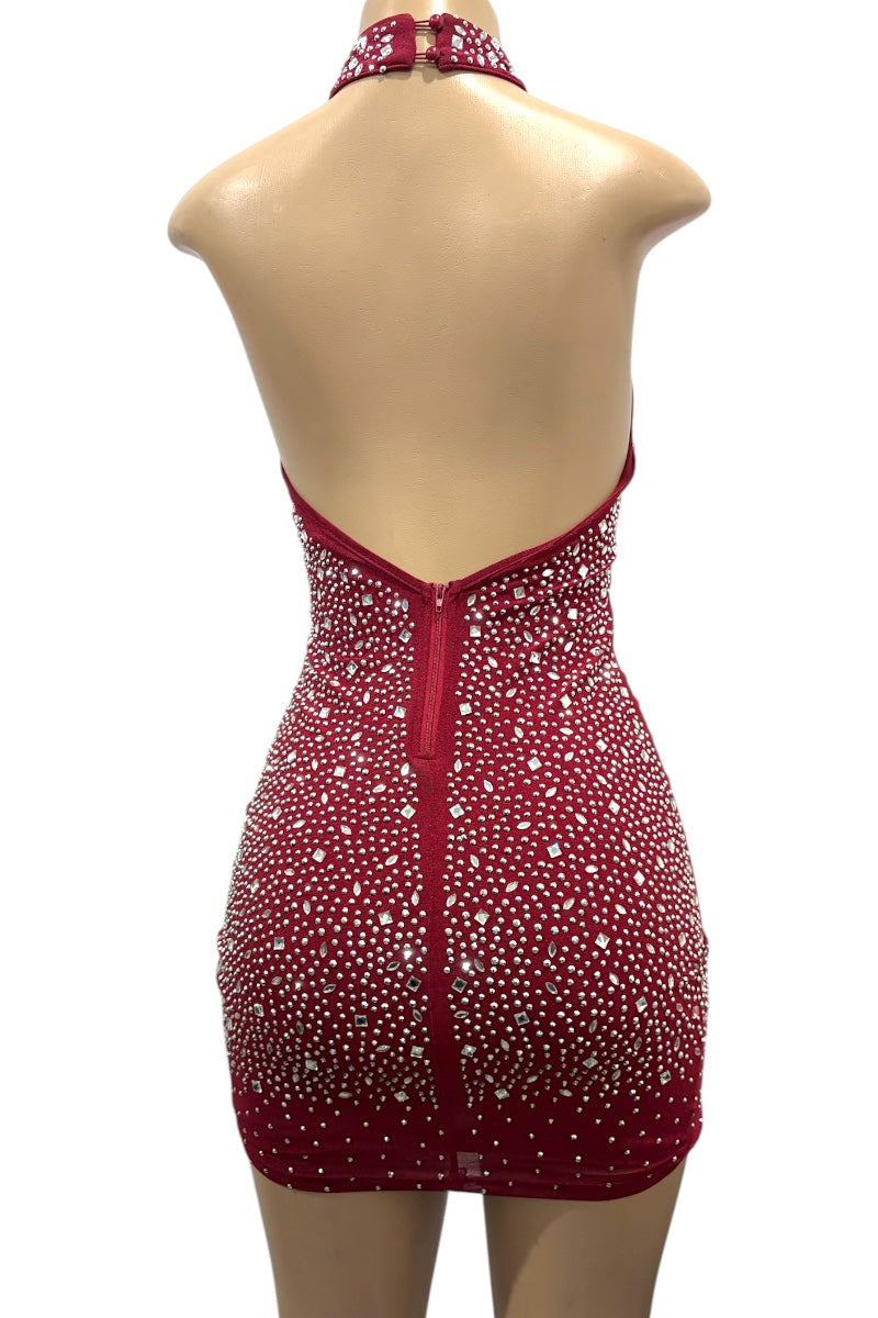 Burgundy dress with rhinestone embellishments on a mannequin against a white background