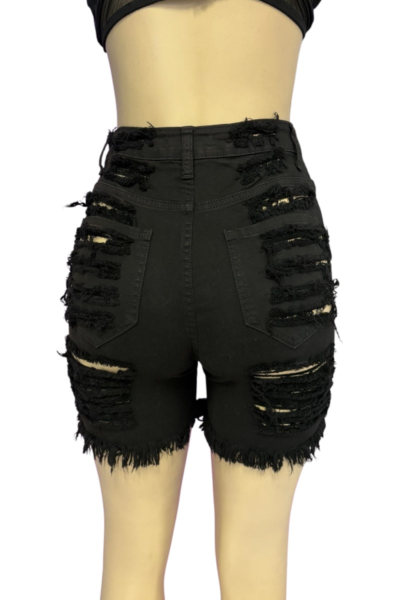 Black distressed denim shorts with heavy frayed rips and raw hems, shown on a mannequin from the back against a white background.