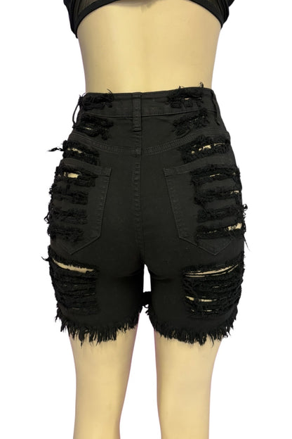 Black distressed denim shorts with heavy frayed rips and raw hems, shown on a mannequin from the back against a white background.