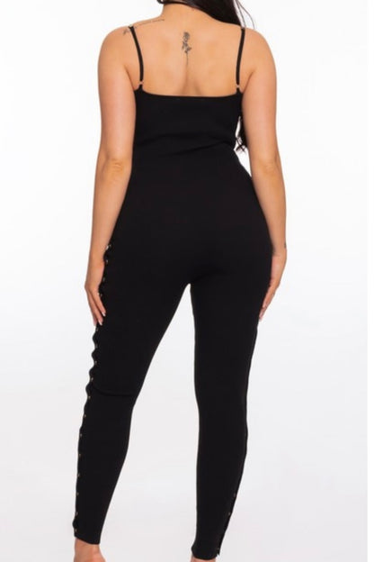 Black jumpsuit worn by a person on a white background