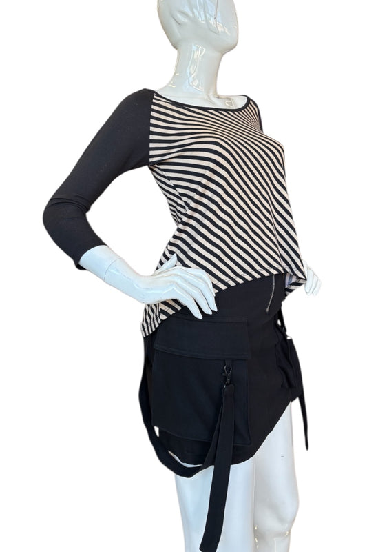 Mannequin wearing a black and beige striped top with a black skirt on a white background