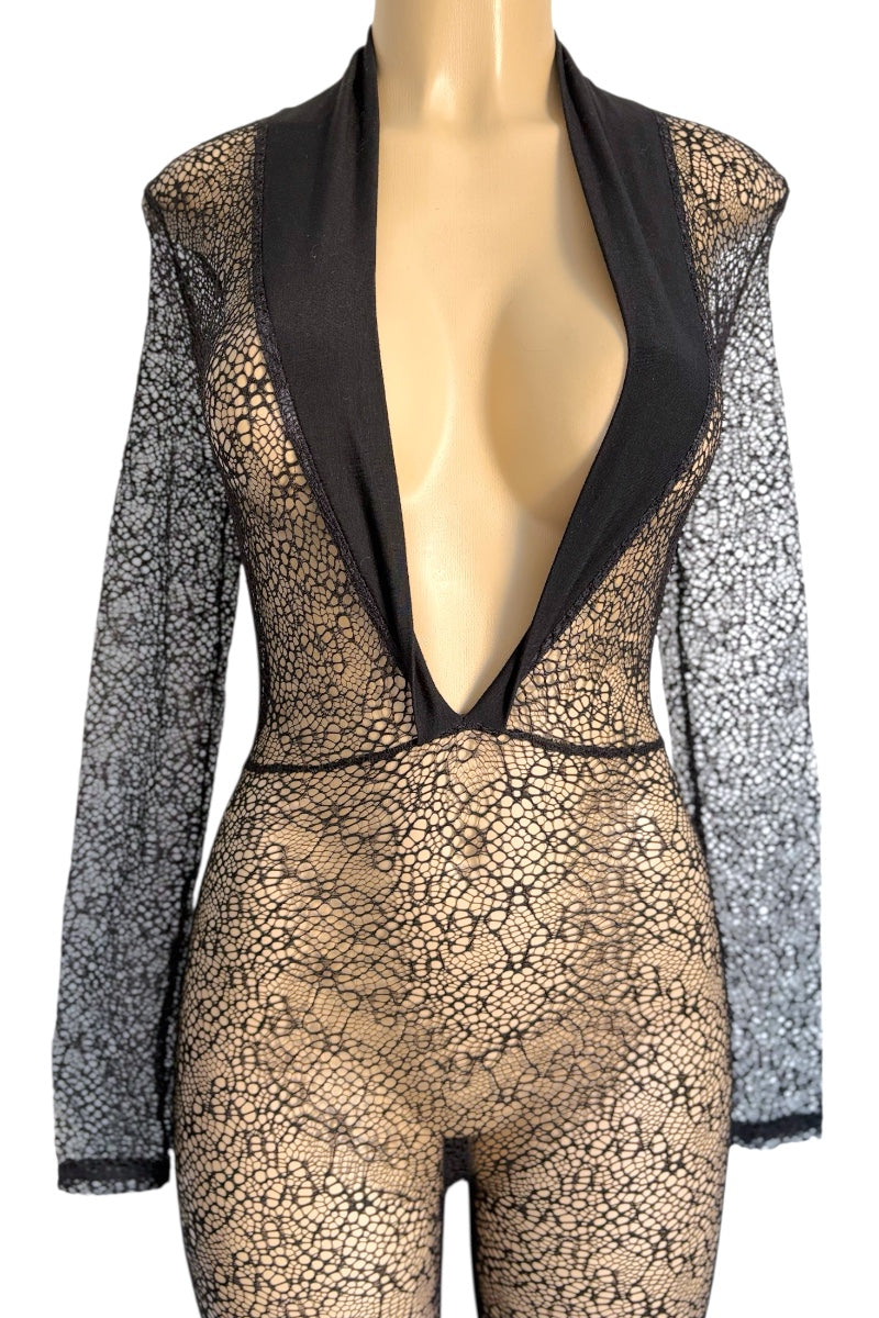 Mannequin wearing a black jumpsuit with long sleeves on a white background