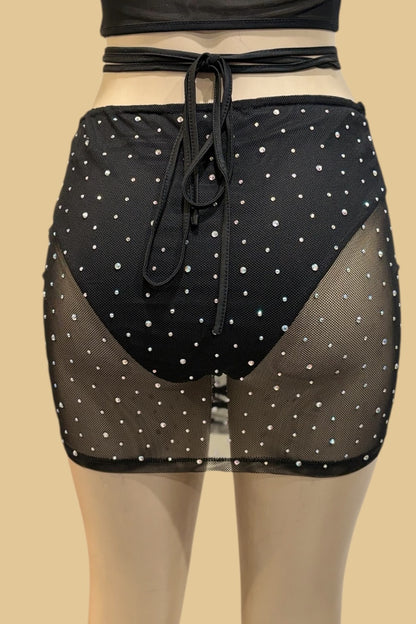 Black polka dot mesh skirt on a beige background