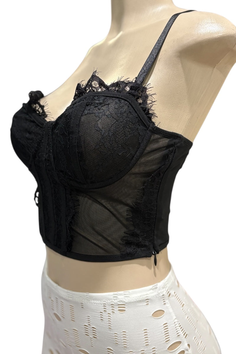 Black lace bra on a mannequin with a white lace garment underneath.