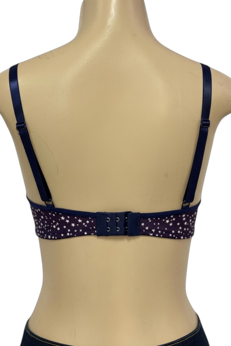 Navy blue bra with star pattern on a beige mannequin