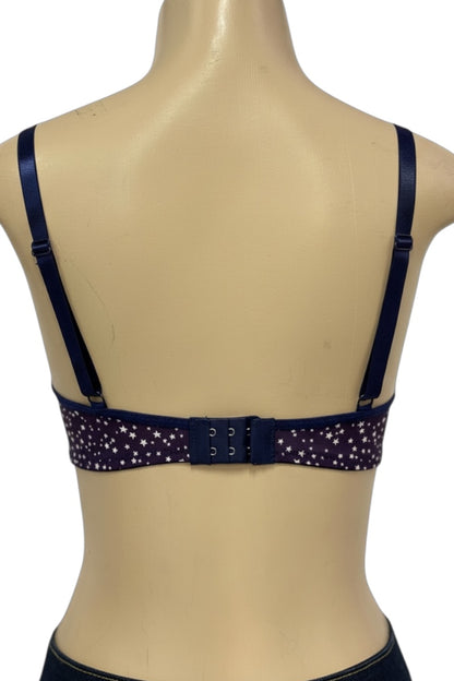Navy blue bra with star pattern on a beige mannequin
