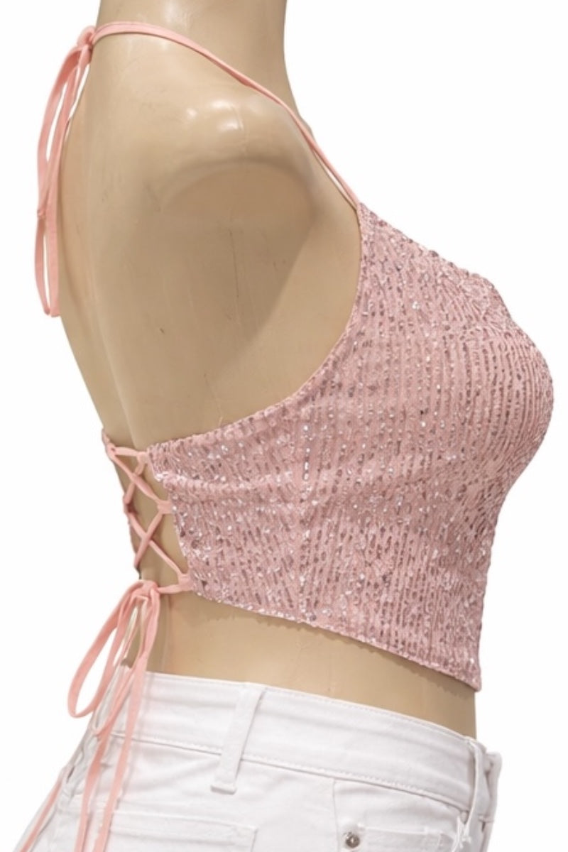 Pink crop top with lace-up back on a mannequin against a white background