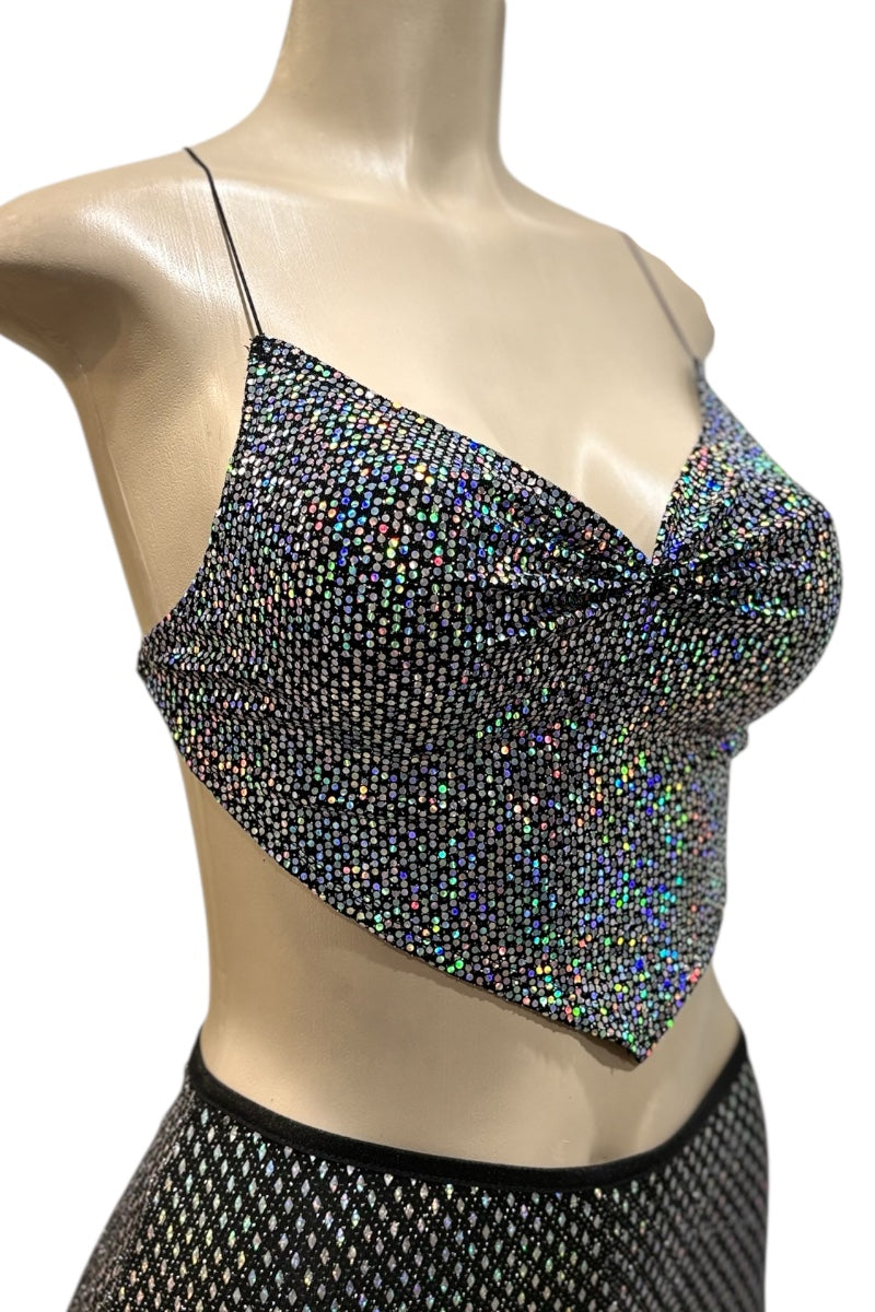 Mannequin wearing a sparkling top and shorts with a white background