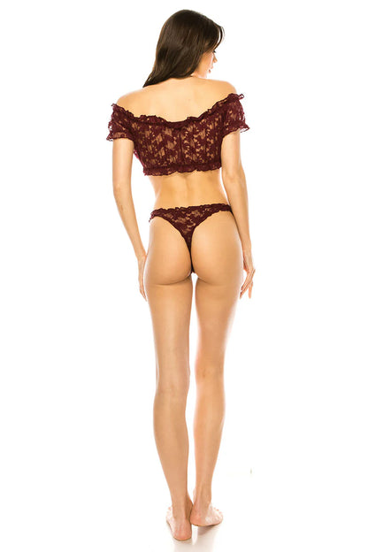 Woman wearing a lace lingerie set on a white background