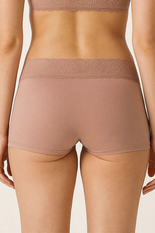 Person wearing a pair of beige underwear on a plain background
