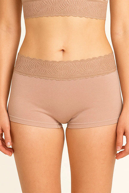 Beige lace-trimmed underwear on a plain background