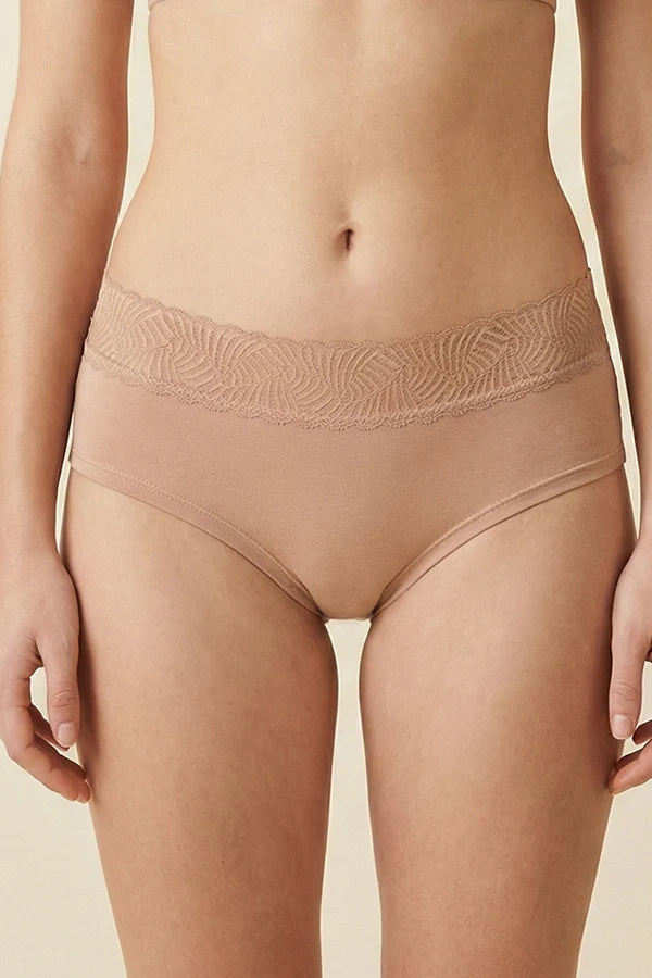 Beige underwear with lace waistband on a beige background
