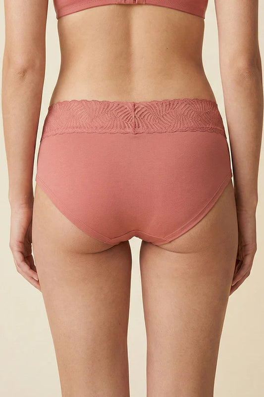Person wearing a pink MauveGlow high-waisted underwear on a beige background