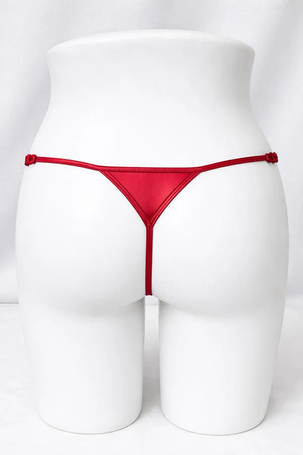 Red thong on a white mannequin against a white background