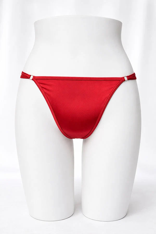 Red thong on a white mannequin against a white background