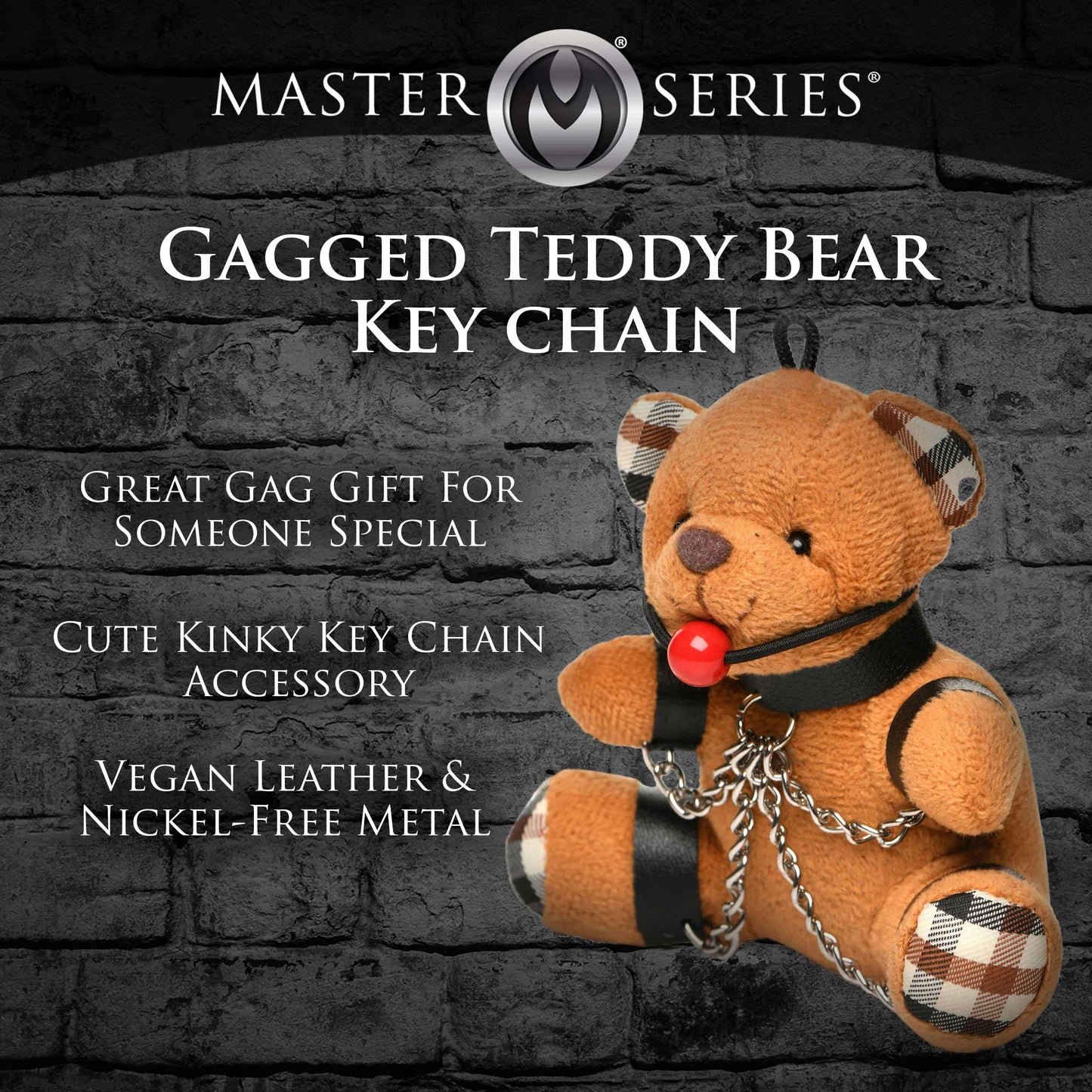Gagged teddy bear keychain with text on a dark brick wall background