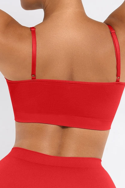 Red bralette worn by a person on a plain background