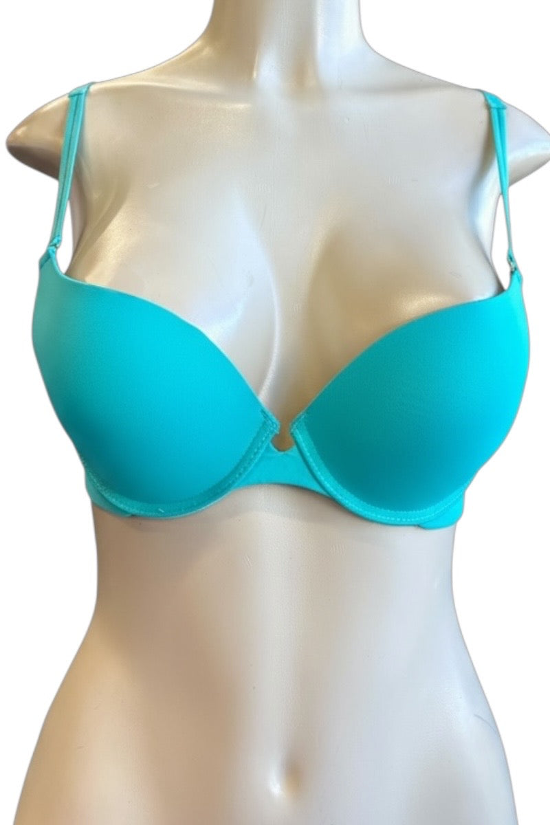 Turquoise bra on a mannequin against a white background