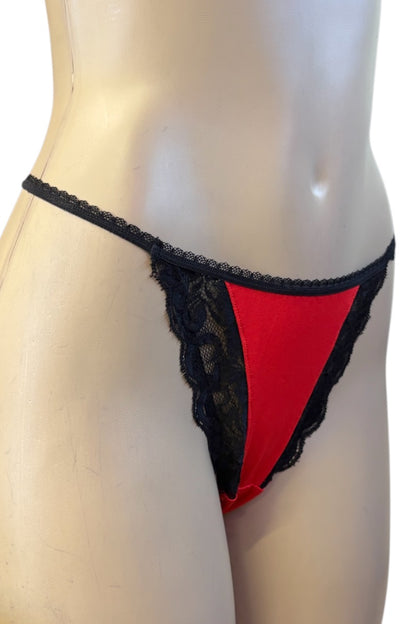 Red and black lace thong underwear displayed on a beige mannequin torso against a white background.